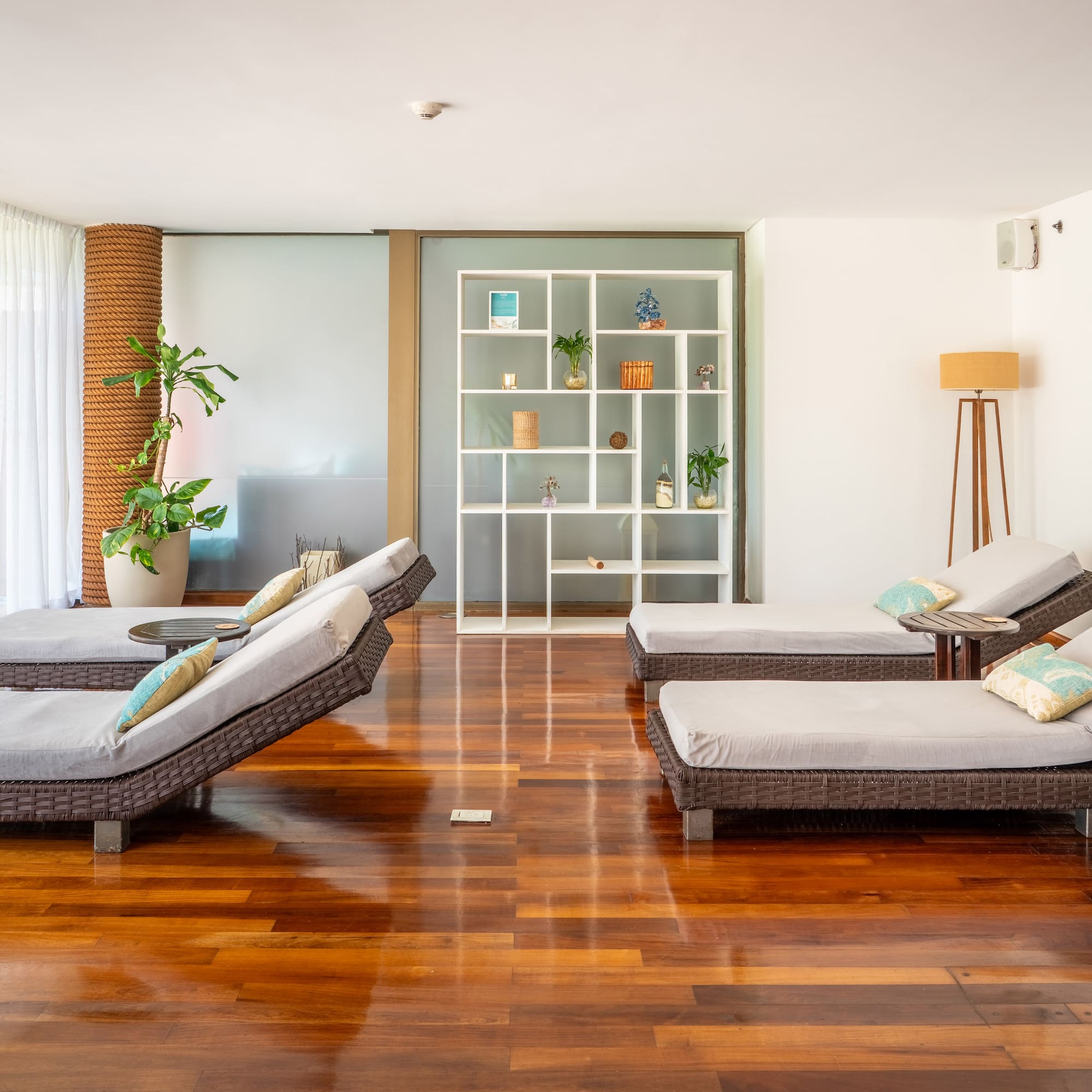 a room with lounge chairs and a bookcase
