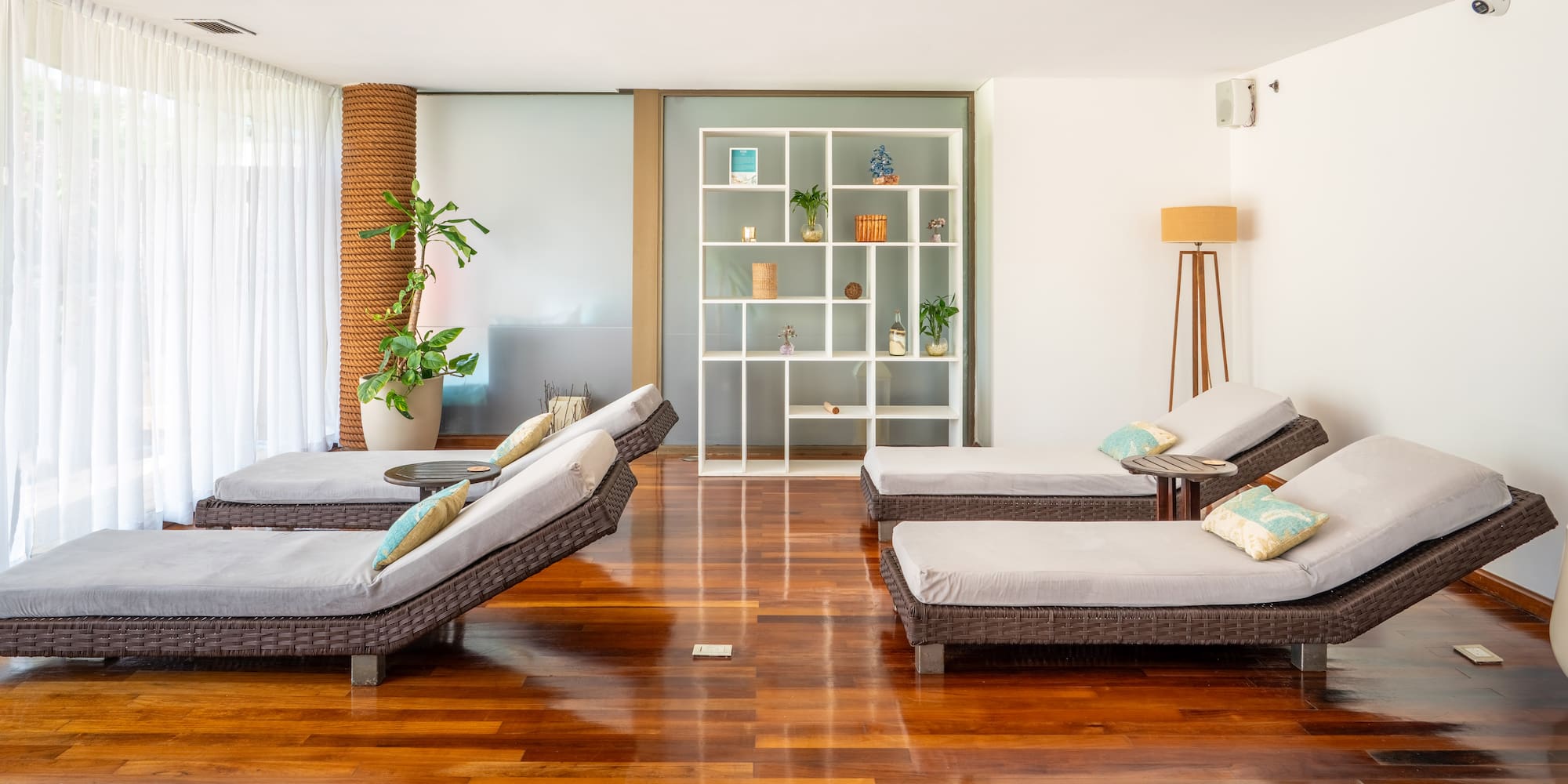 a room with lounge chairs and a bookcase