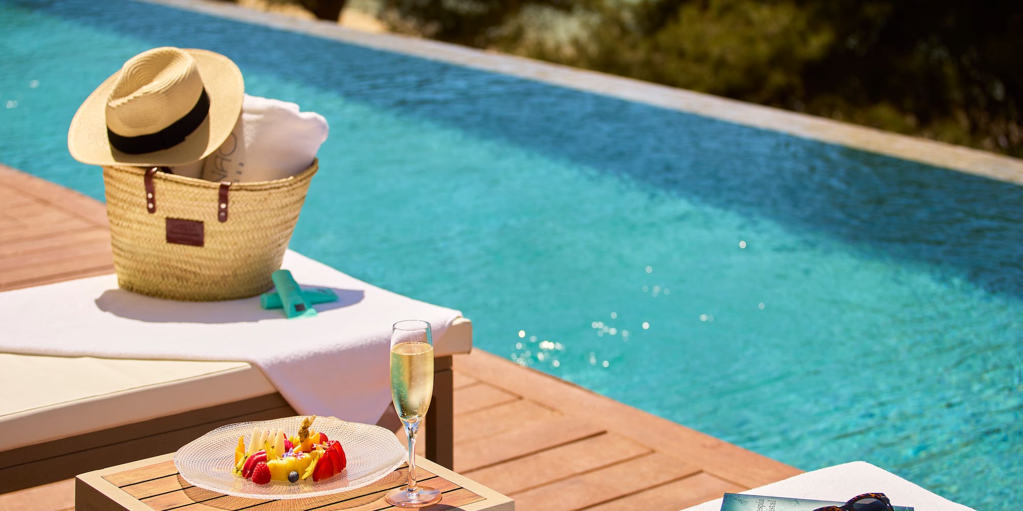 a pool with a table and a basket and a book