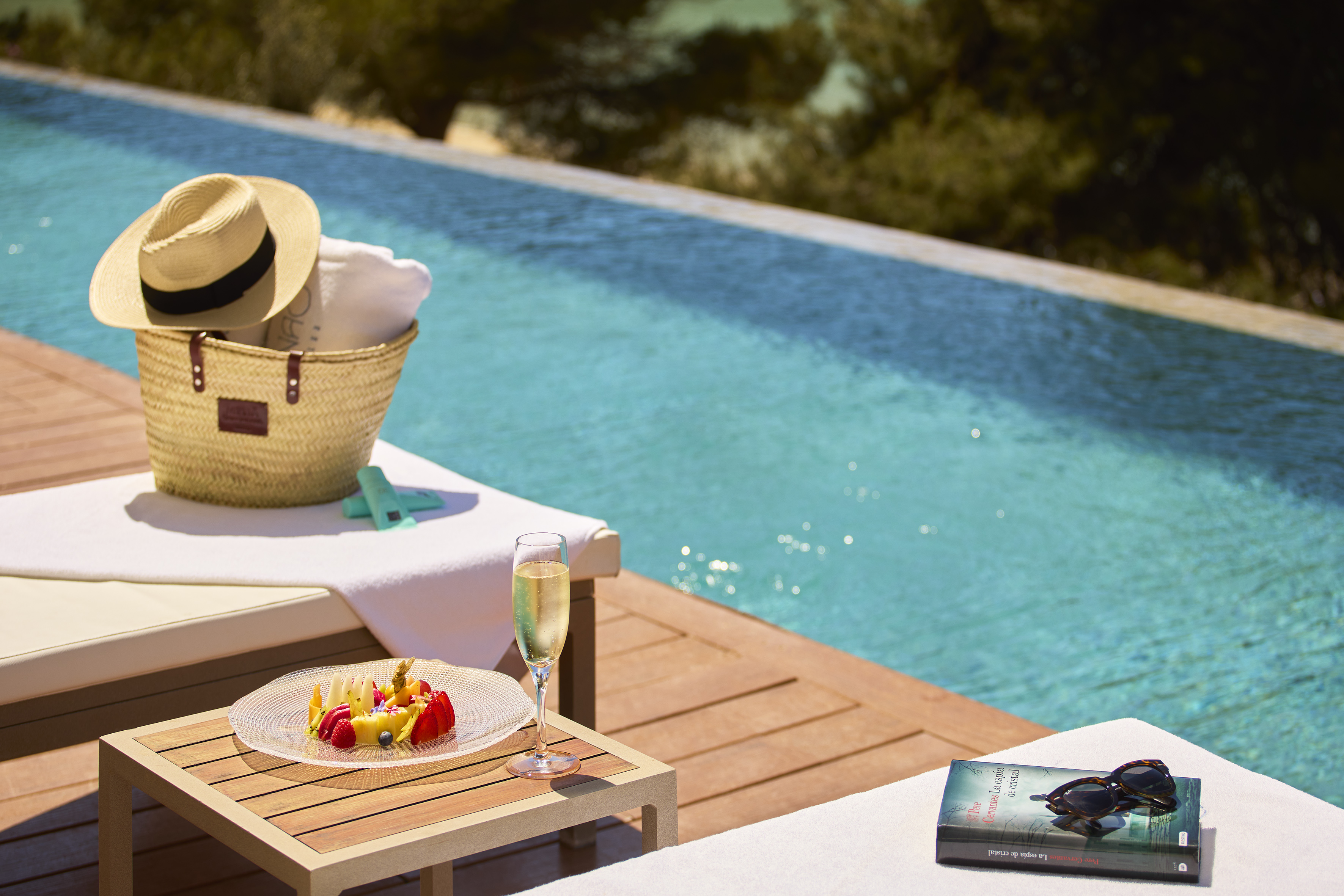 a pool with a table and a basket and a book