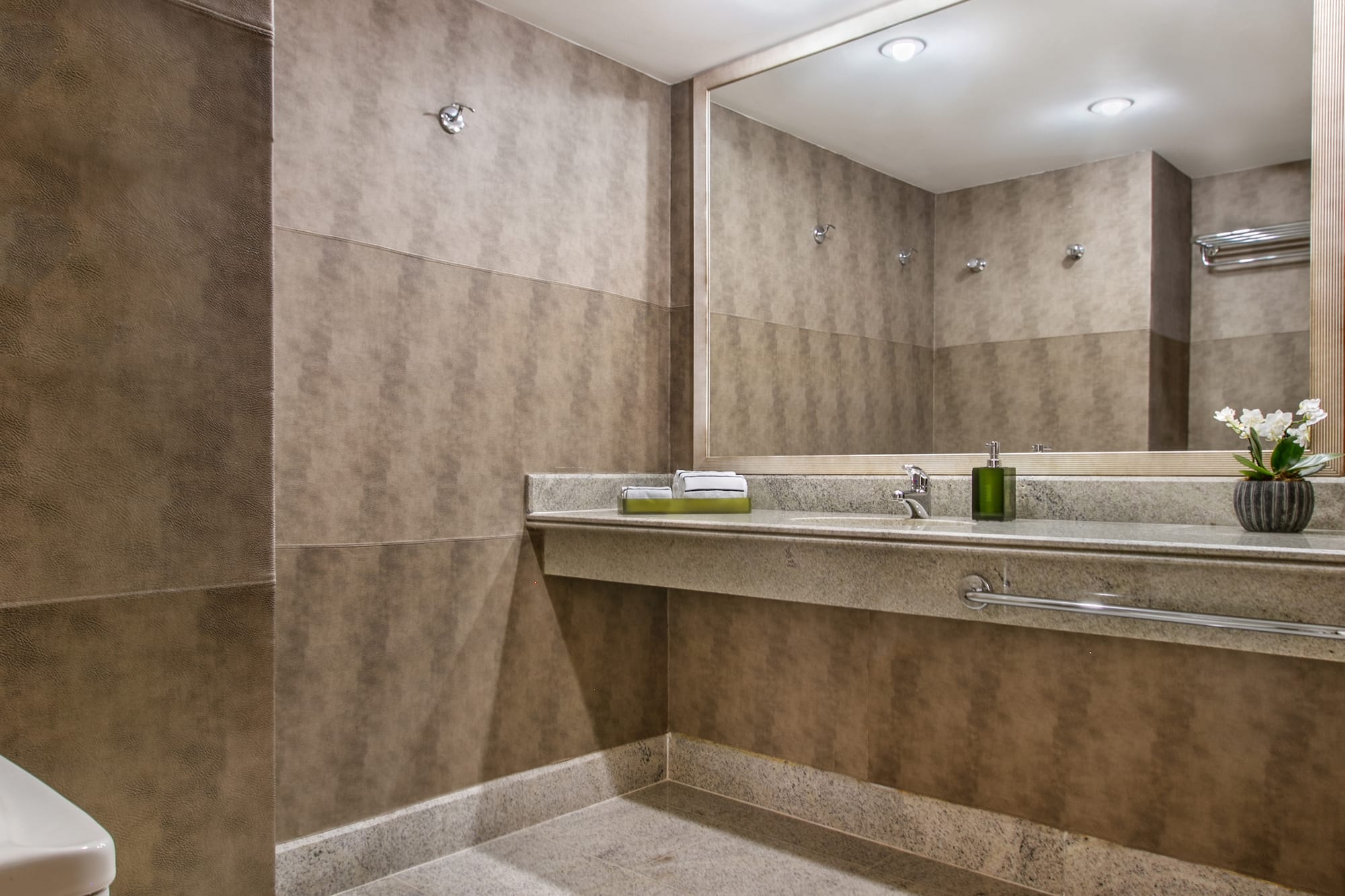 a bathroom with a large mirror and sink