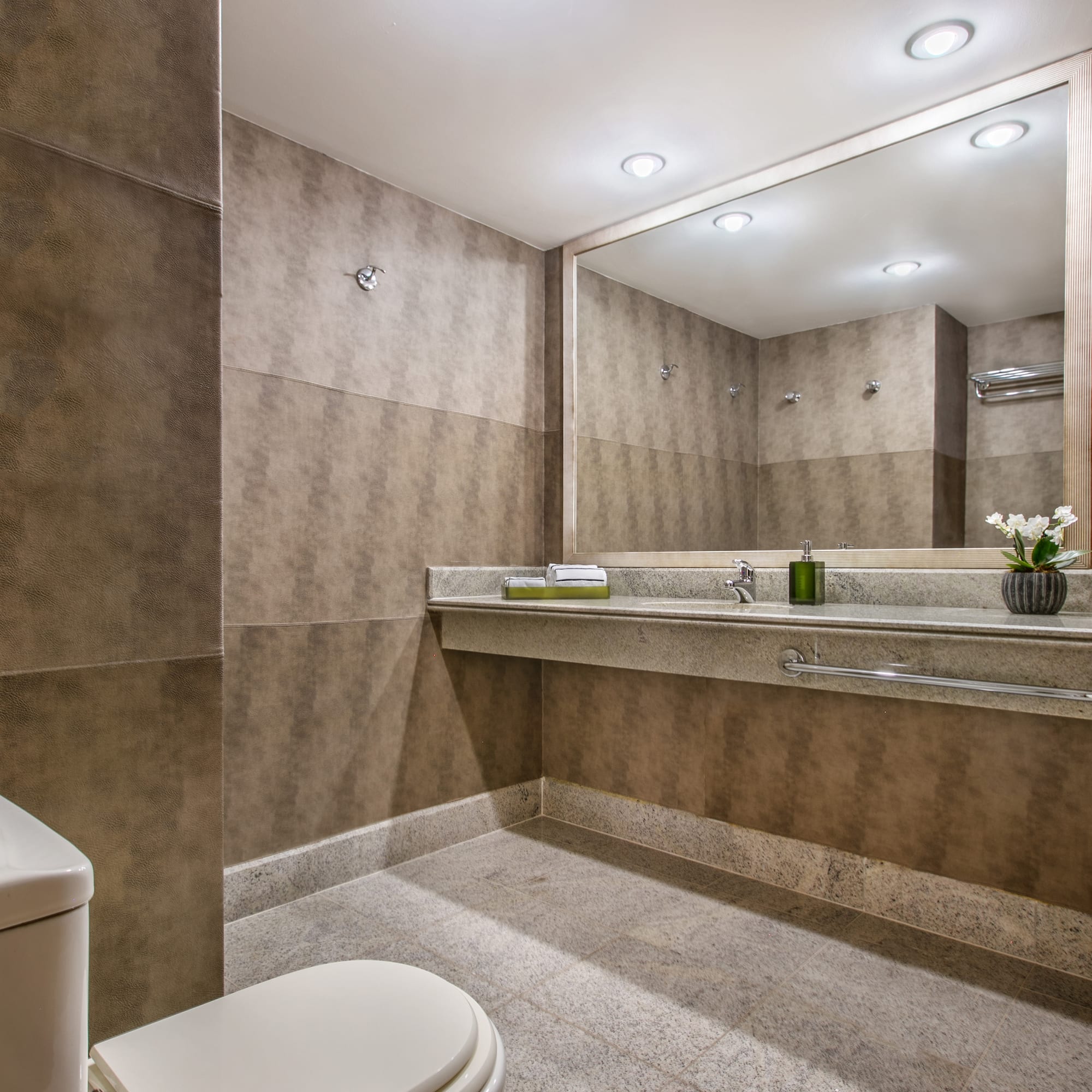 a bathroom with a large mirror and sink