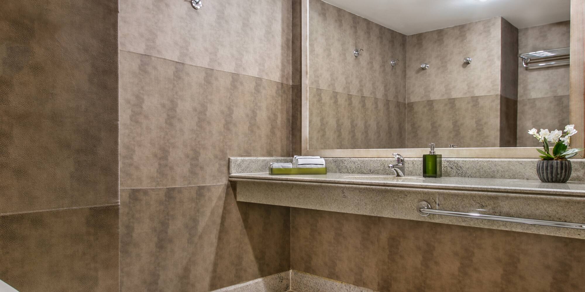 a bathroom with a large mirror and sink