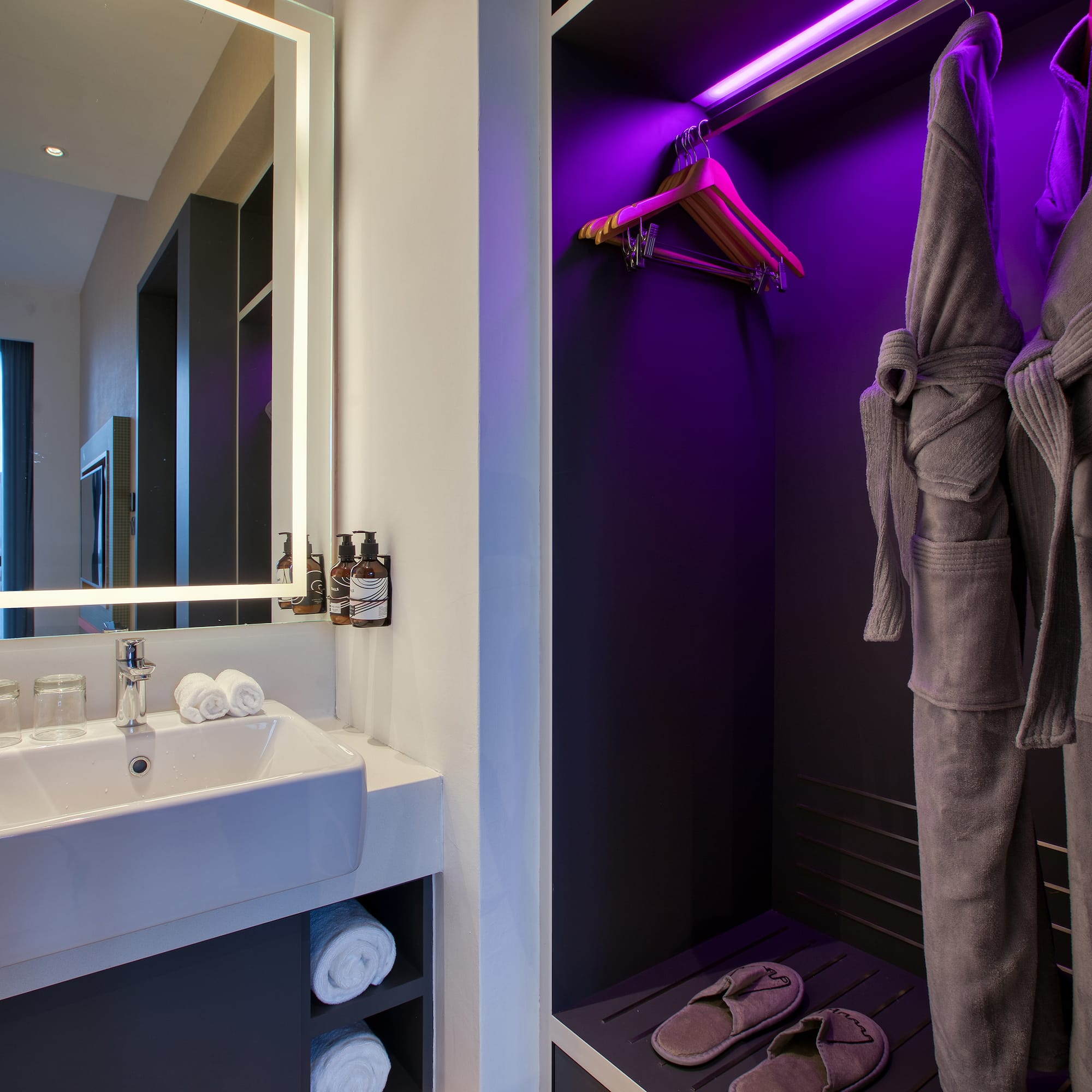 a bathroom with purple lighting