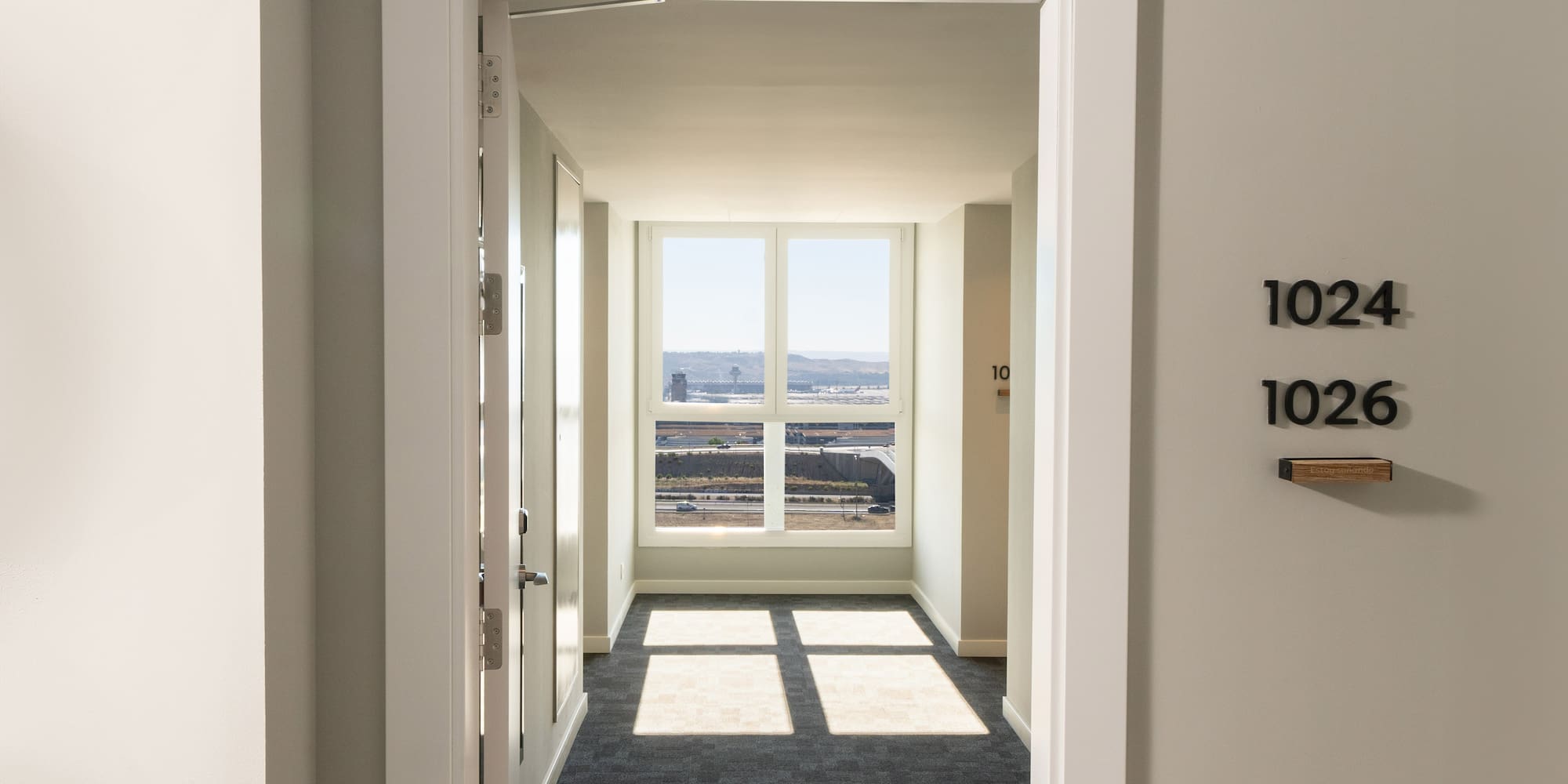 a hallway with a door and a window