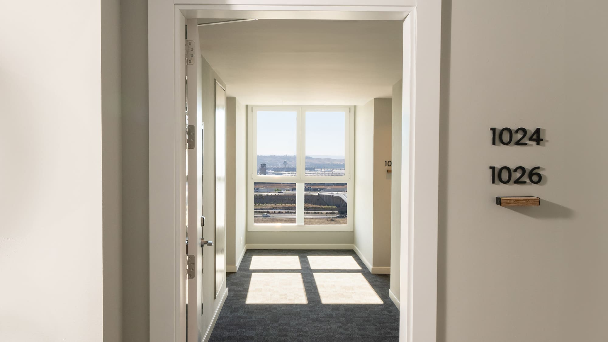 a hallway with a door and a window