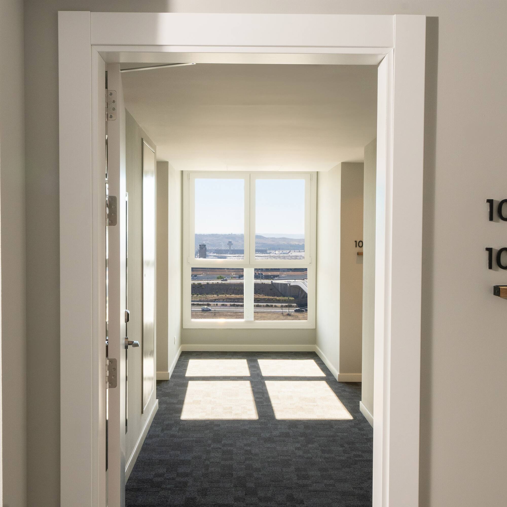 a hallway with a door and a window