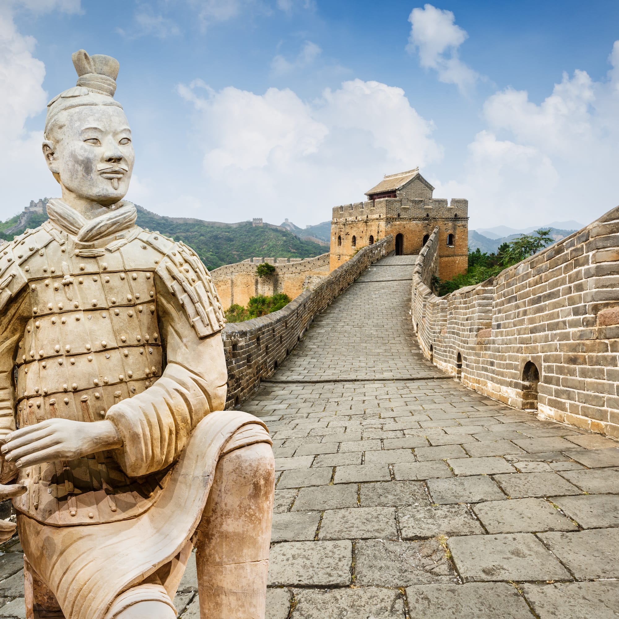 a stone statue on a brick wall