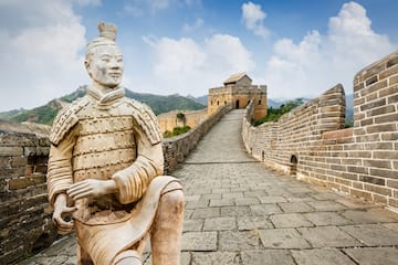 a stone statue on a brick wall