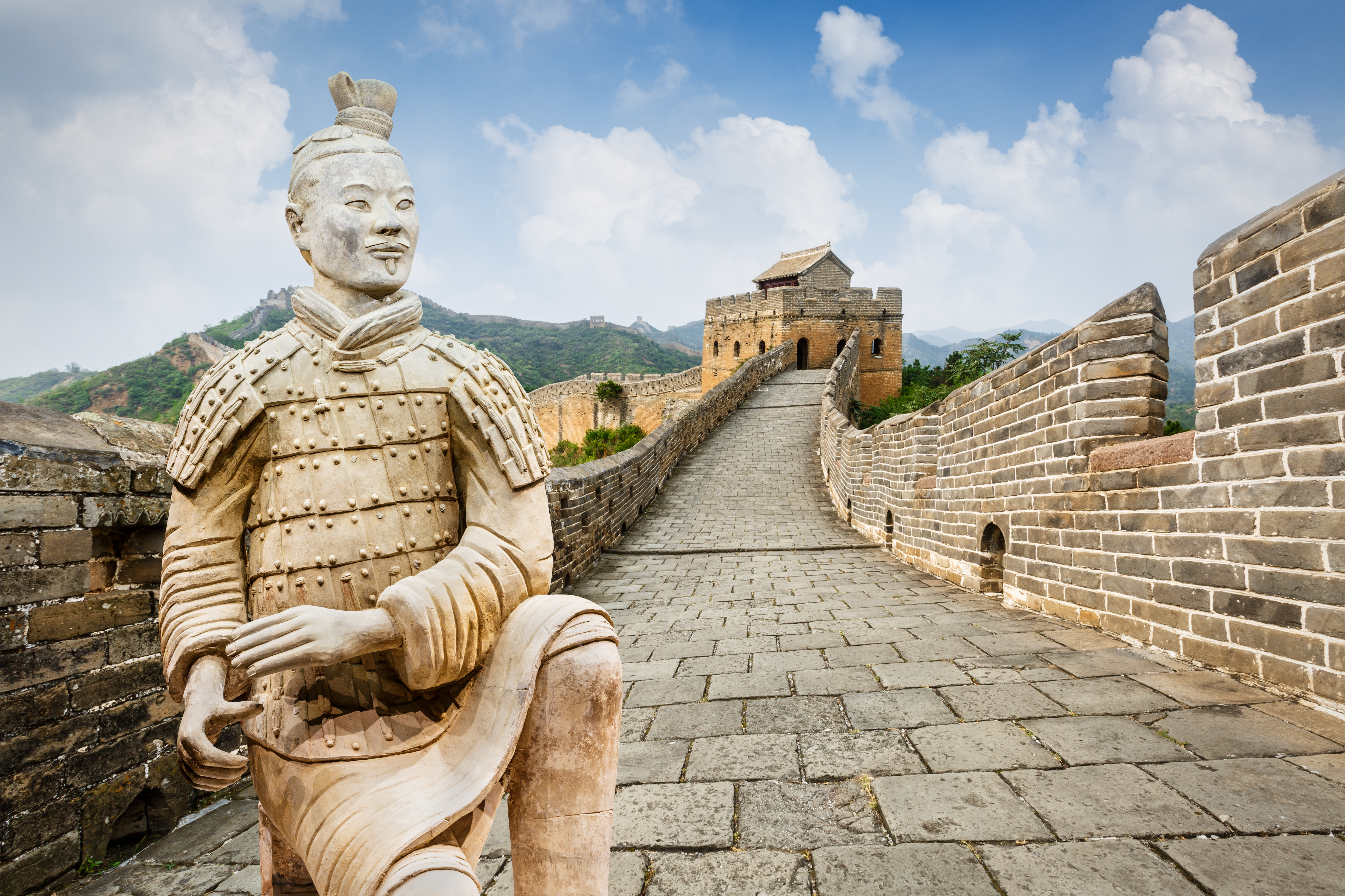 a stone statue on a brick wall