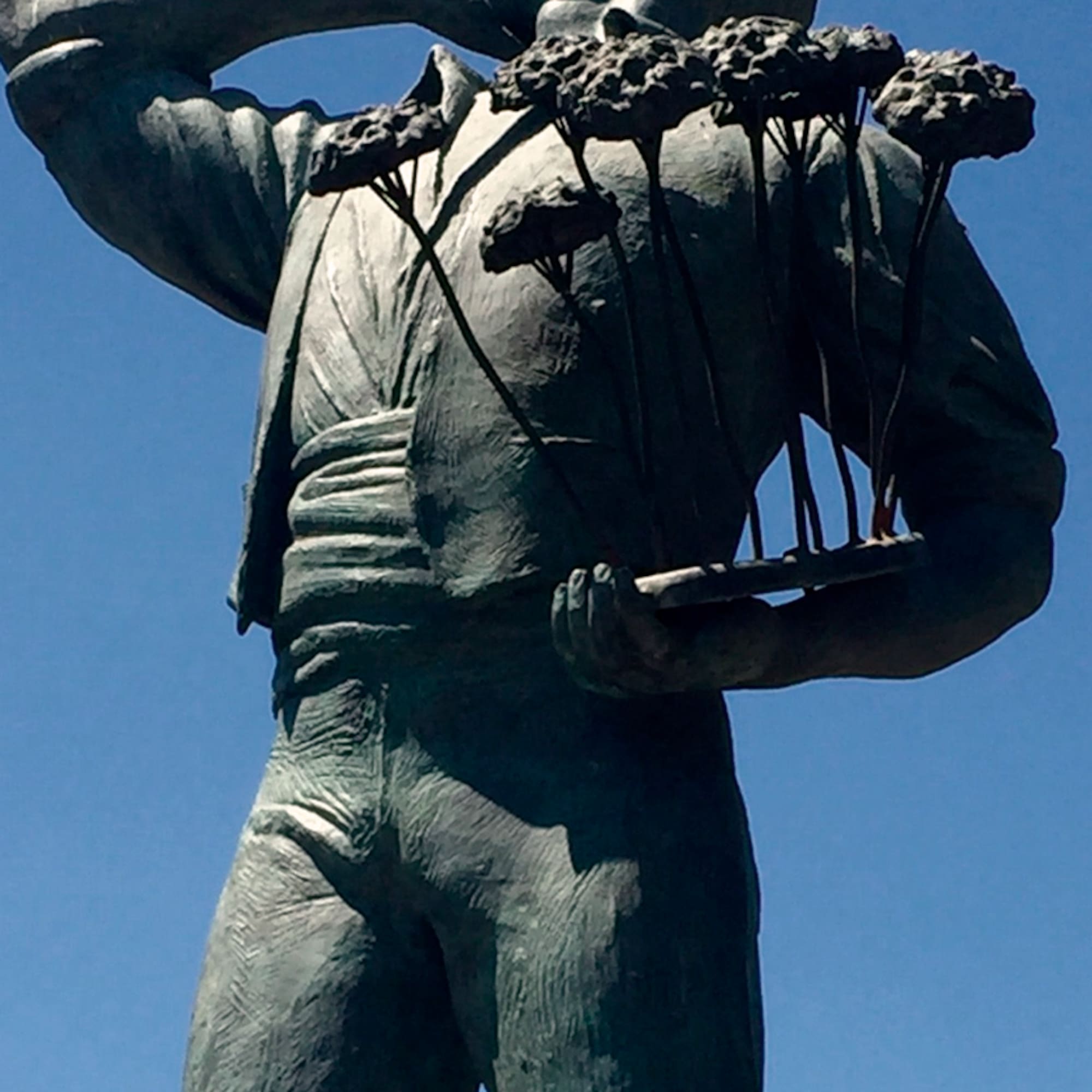 a statue of a man holding flowers