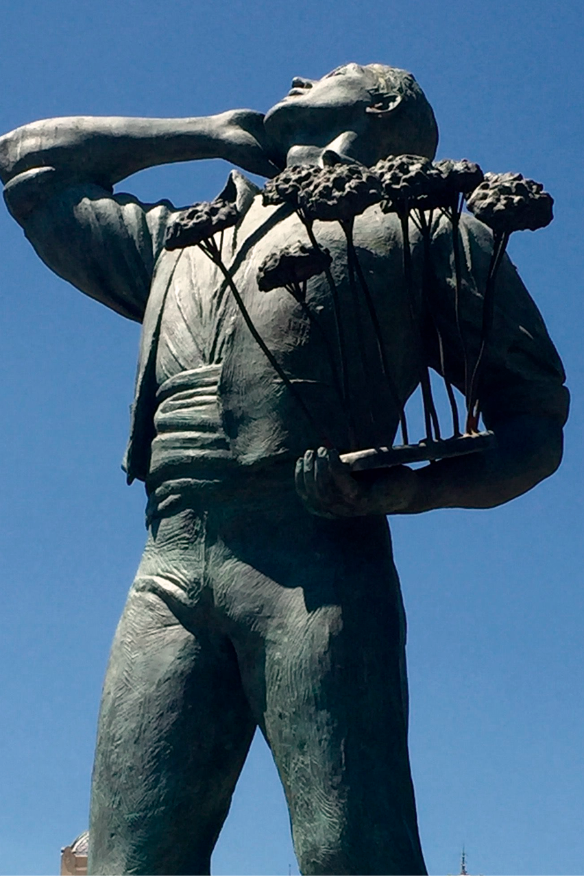 a statue of a man holding flowers
