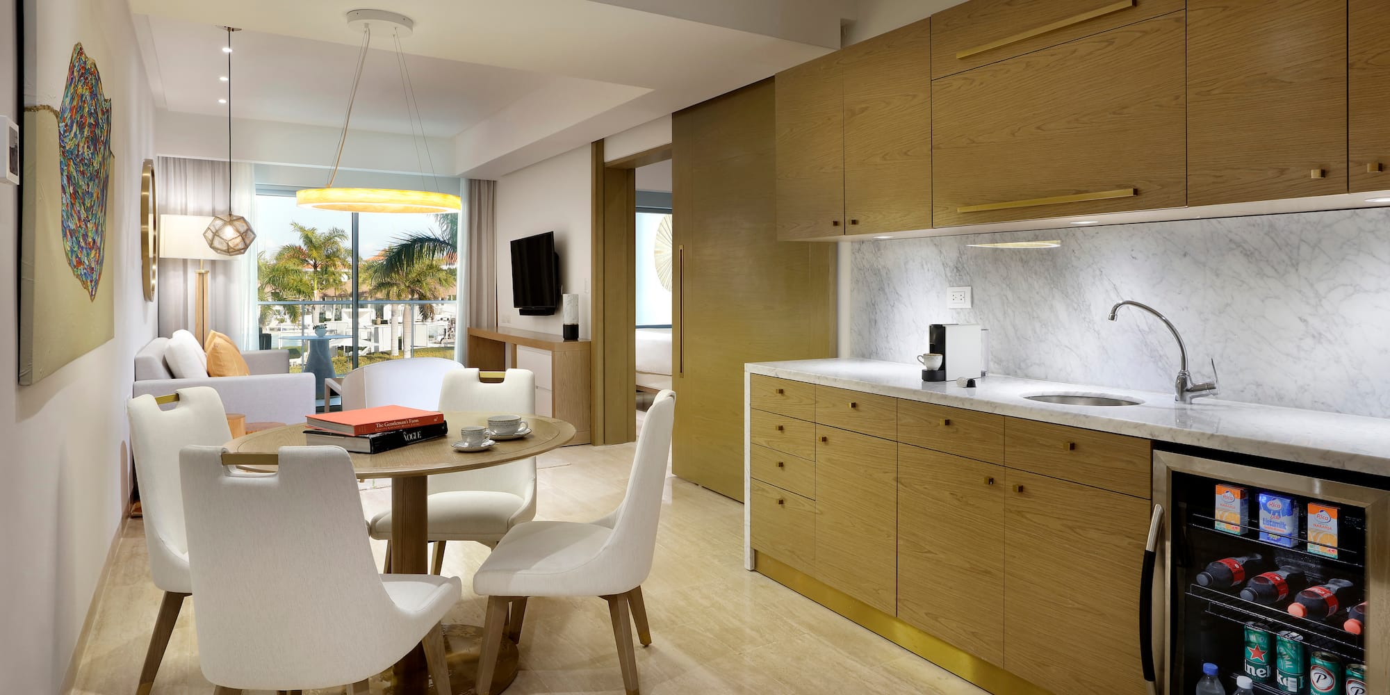 a kitchen and dining area with a table and chairs