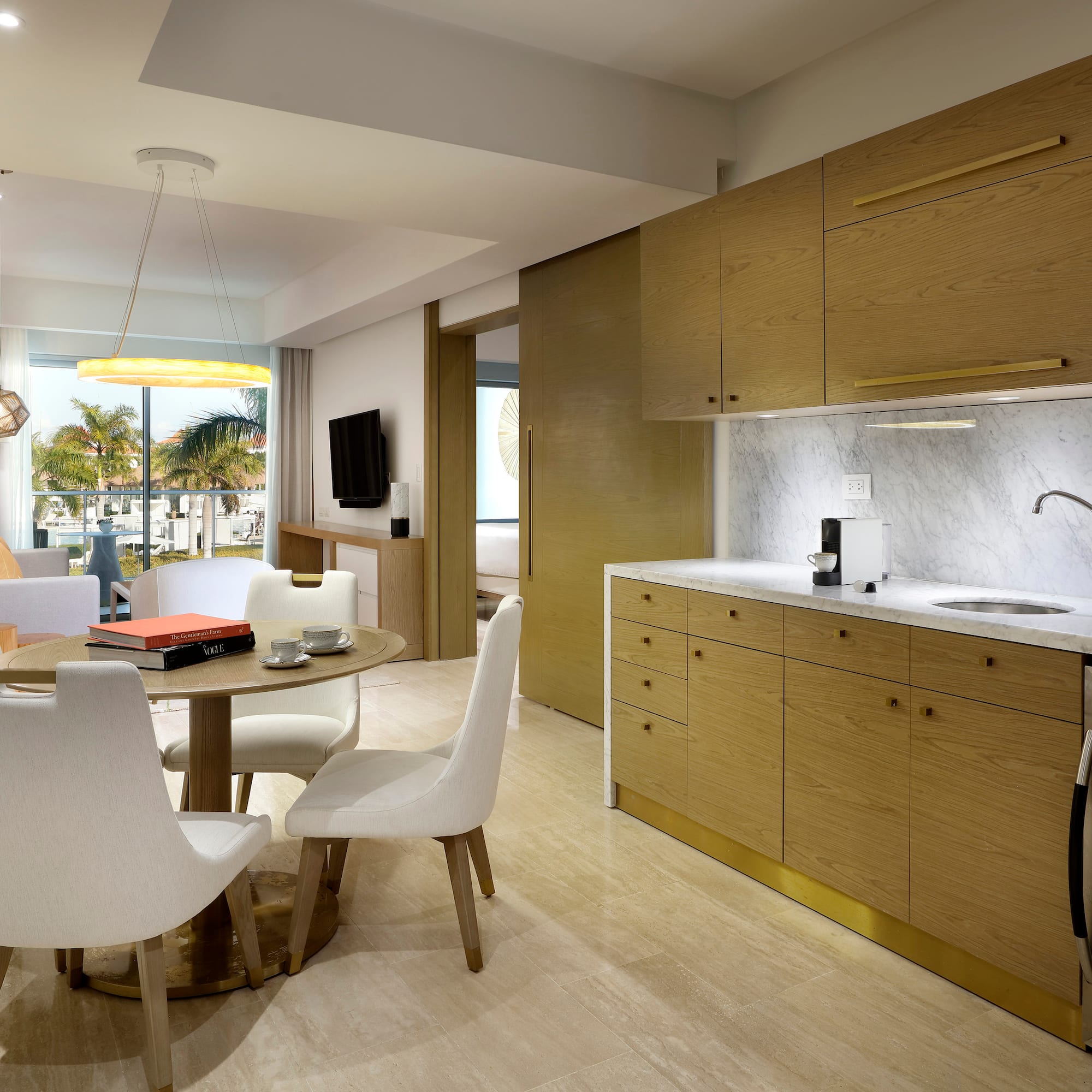 a kitchen and dining area with a table and chairs
