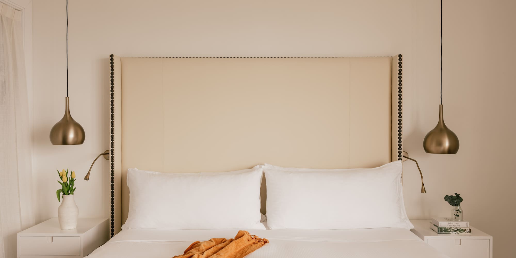 a bed with a blanket and lamps