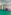 Kids' indoor playroom with green padded floor, art walls, basketball, soccer goal, and pool.