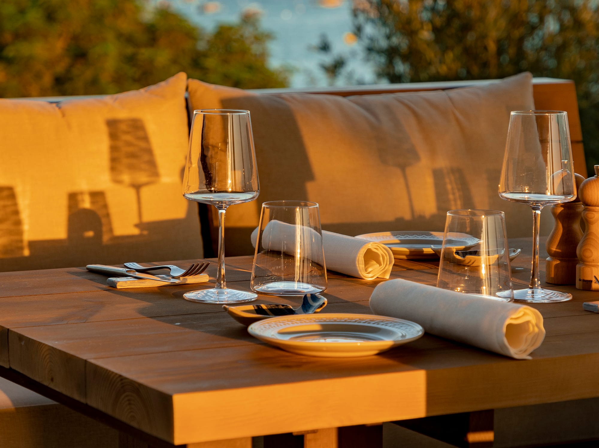 a table with wine glasses and napkins on it