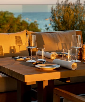 a table with wine glasses and napkins on it