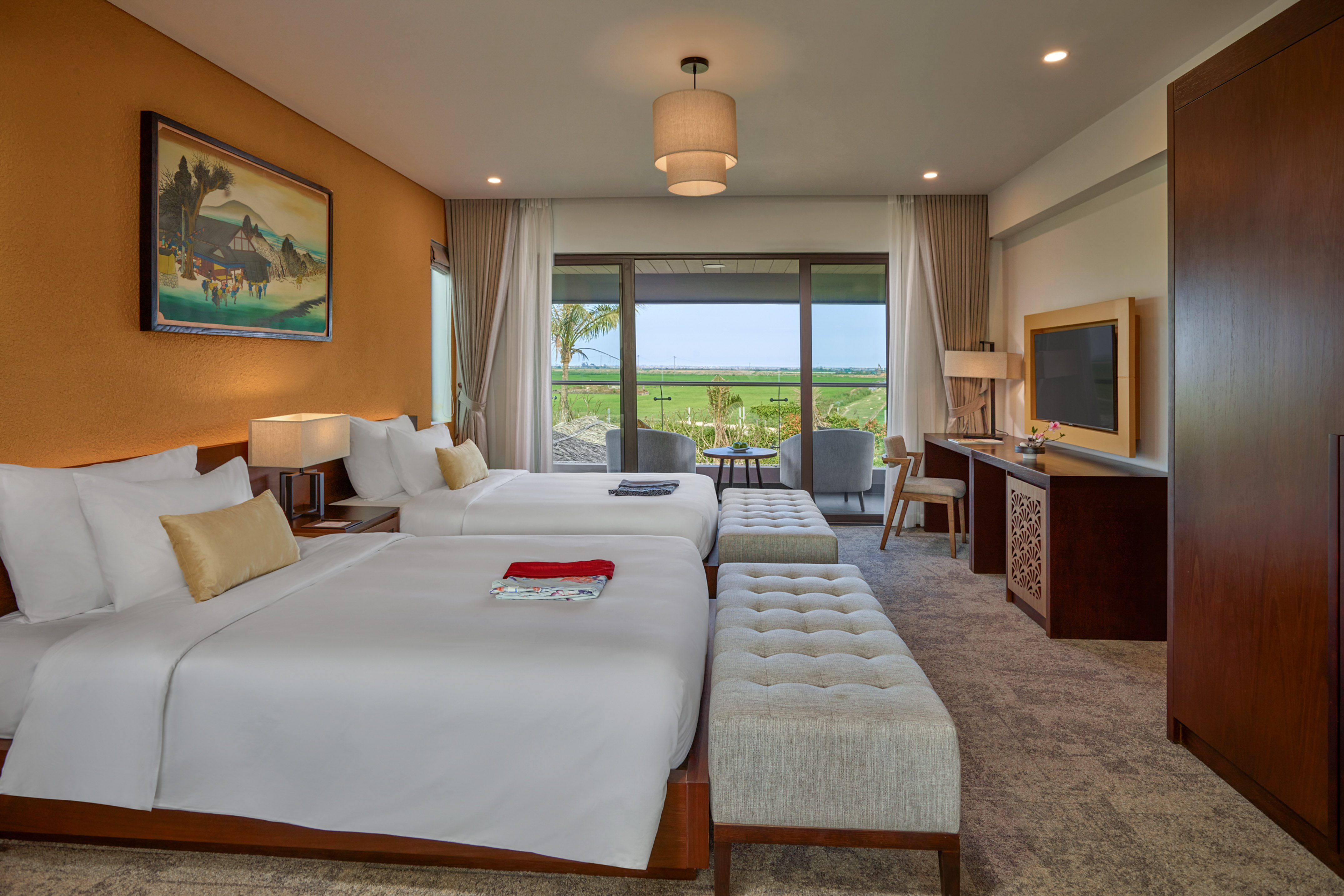 a room with two beds and a television