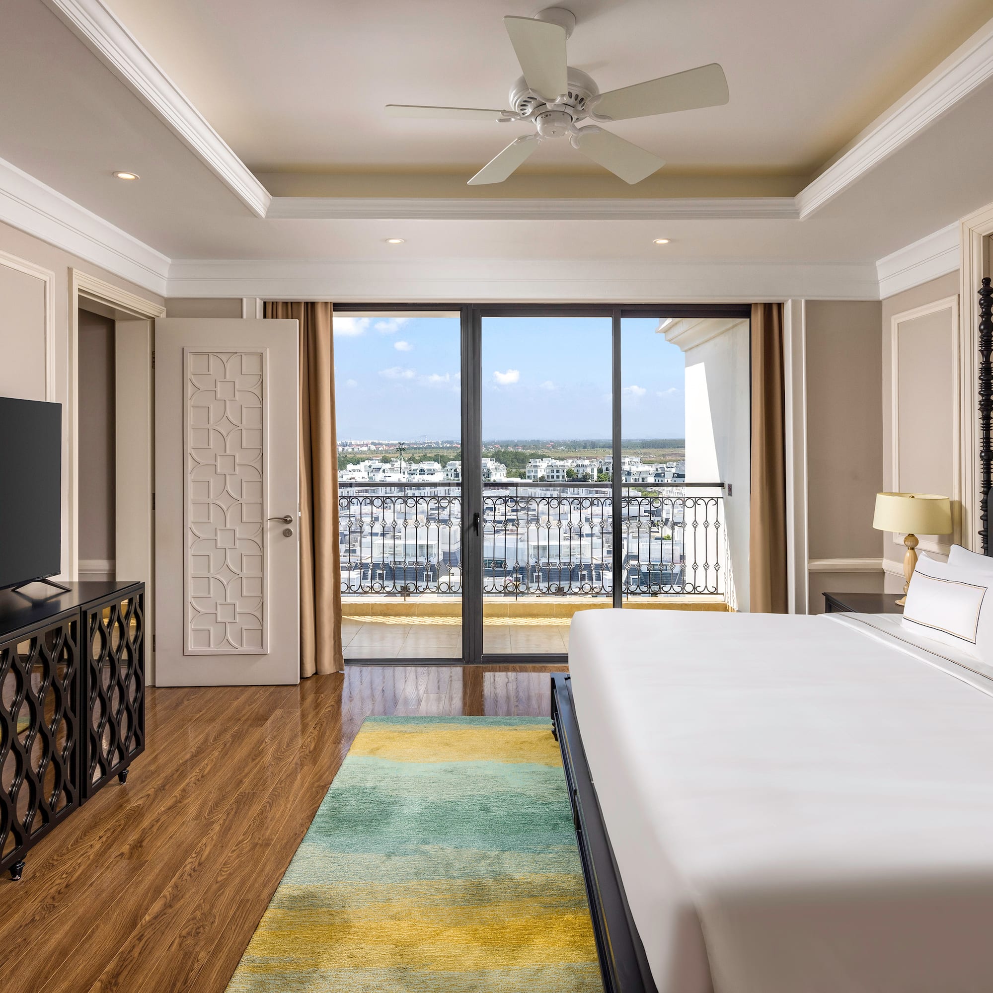 a room with a large bed and a television