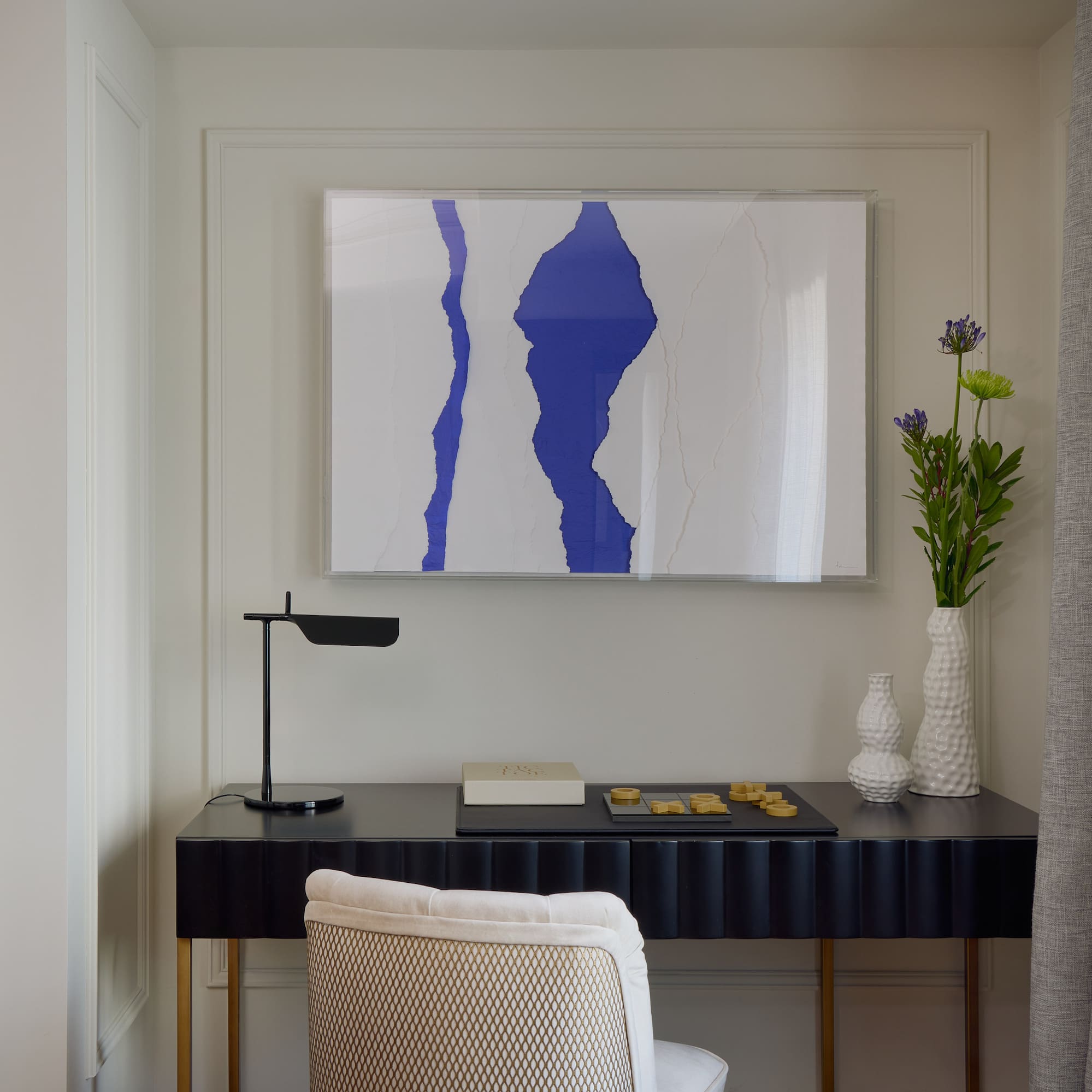 a desk with a painting on it