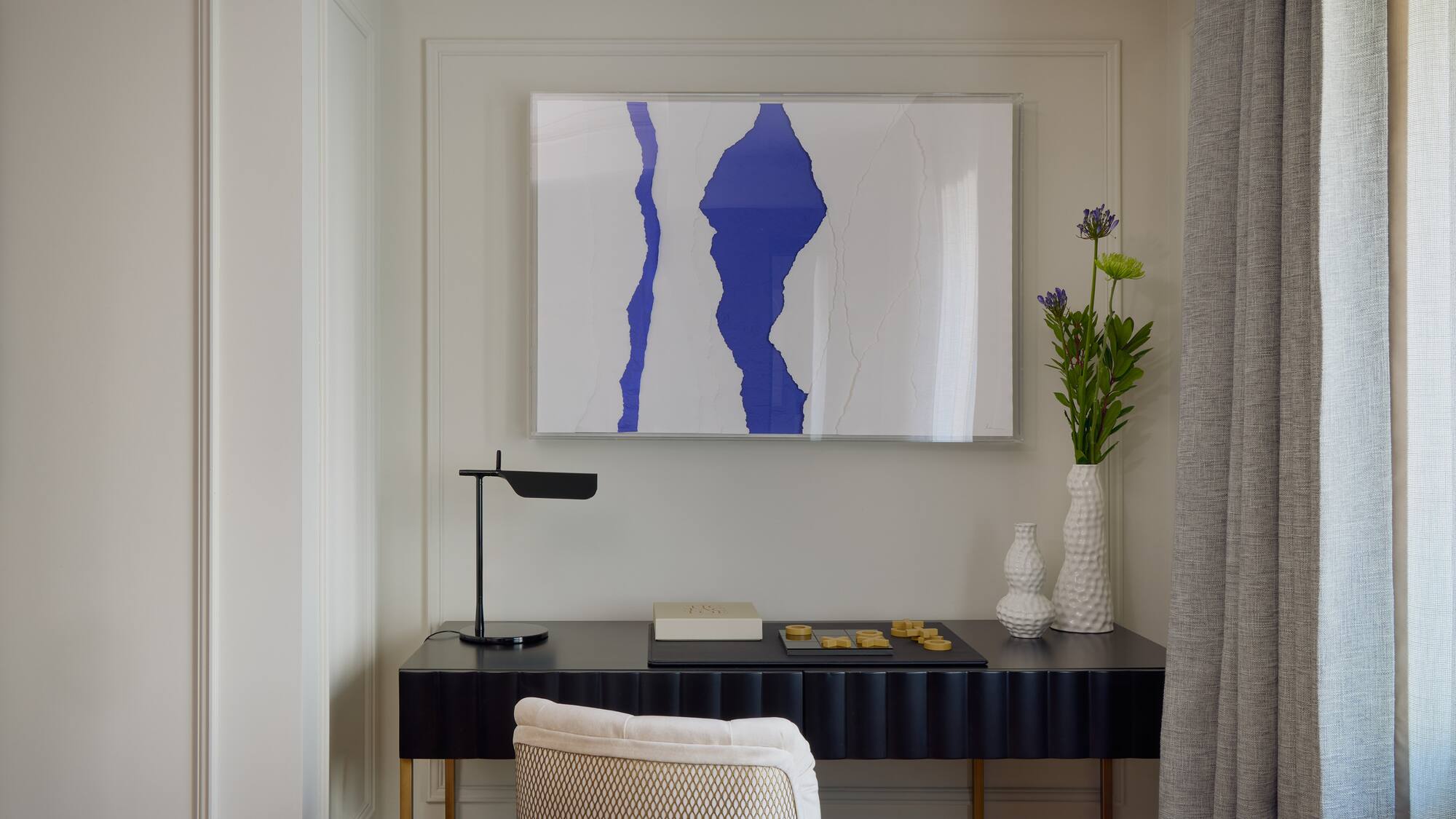 a desk with a painting on it