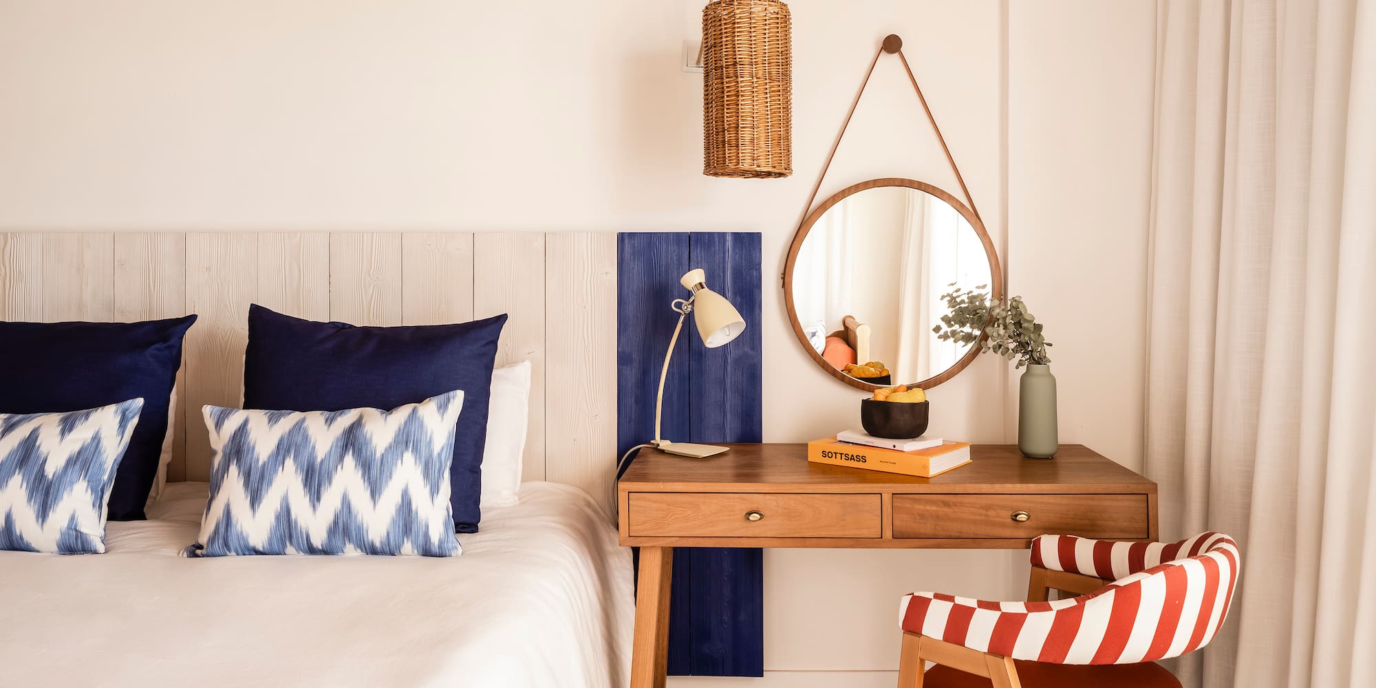 a bedroom with a desk and a mirror