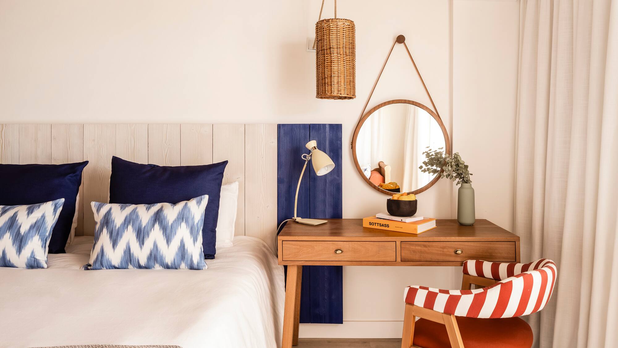 a bedroom with a desk and a mirror