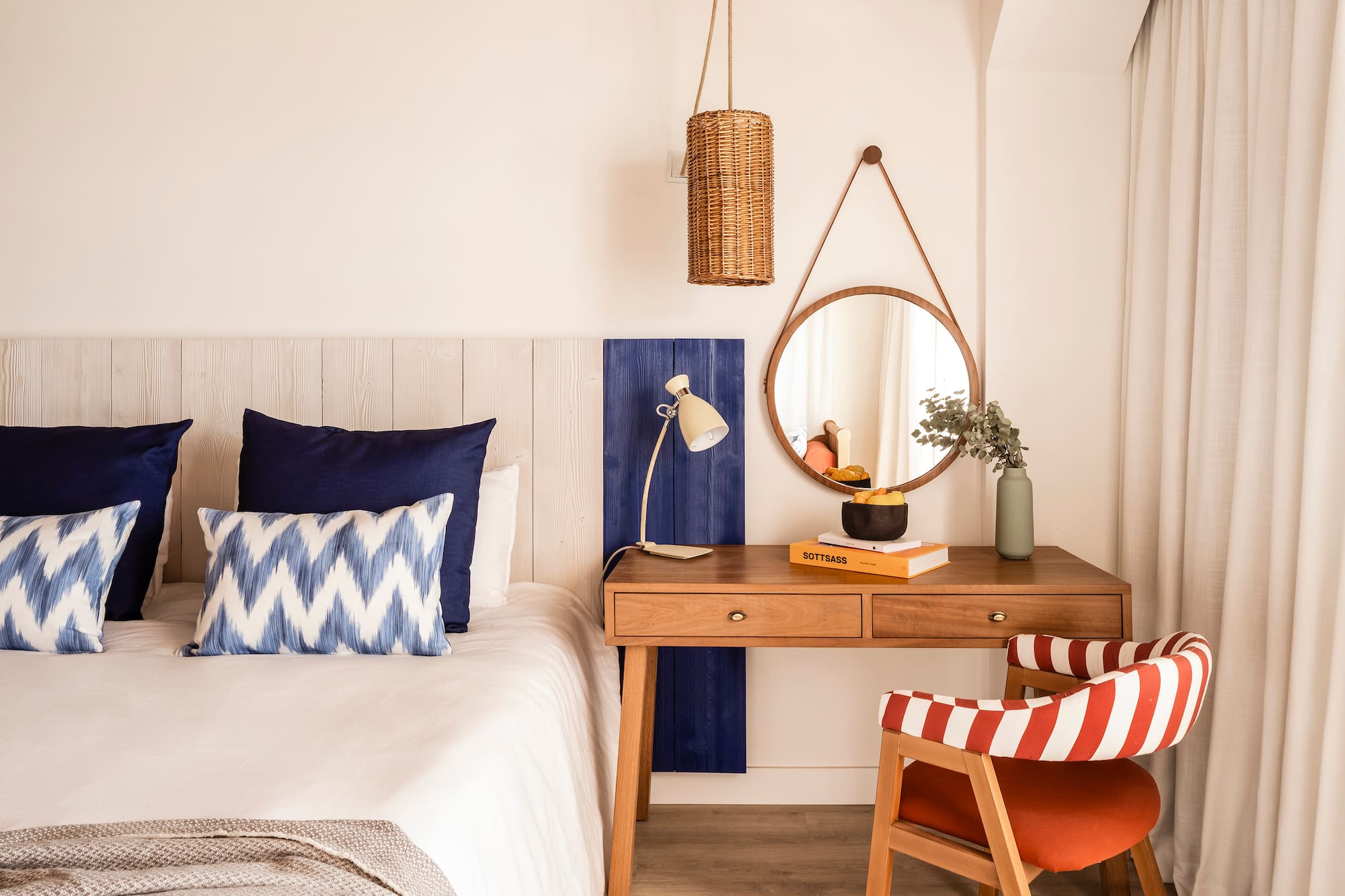 a bedroom with a desk and a mirror