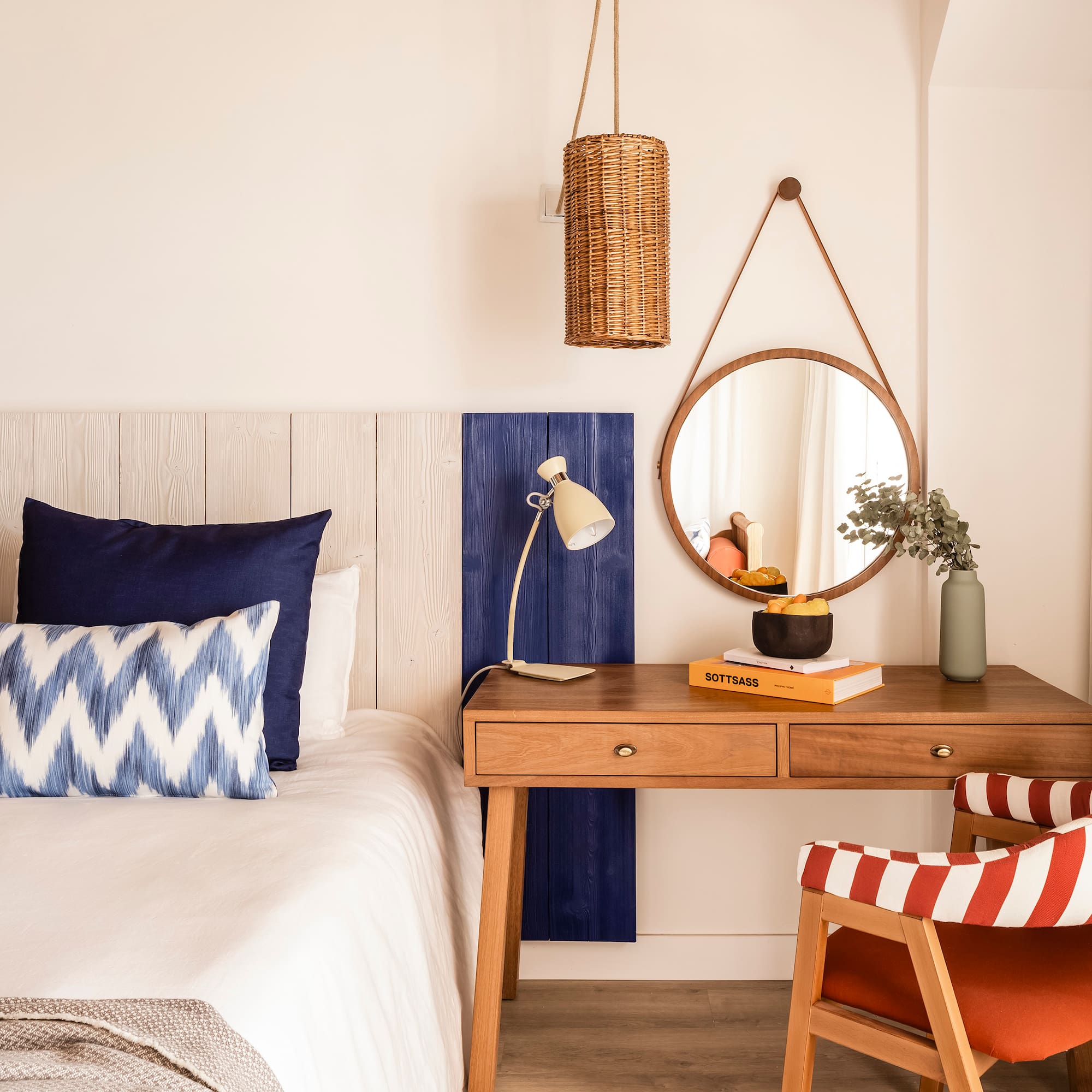 a bedroom with a desk and a mirror