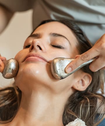 a woman receiving a face massage