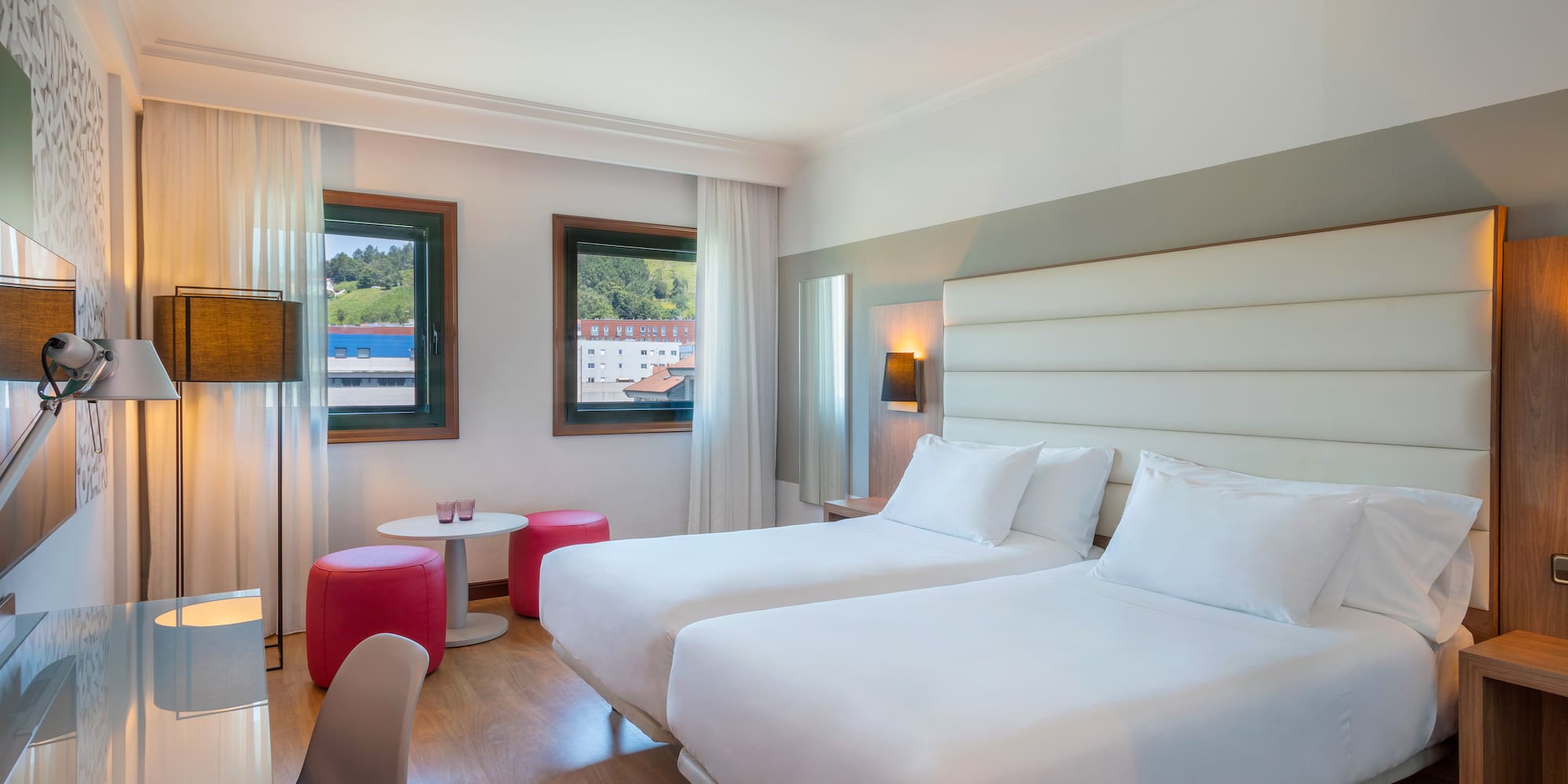 a room with two beds and a table