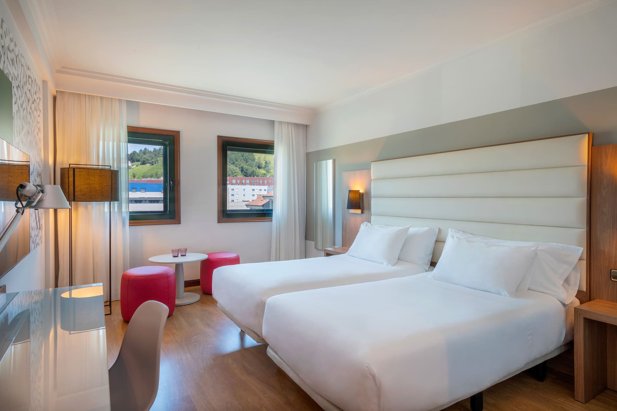 a room with two beds and a table