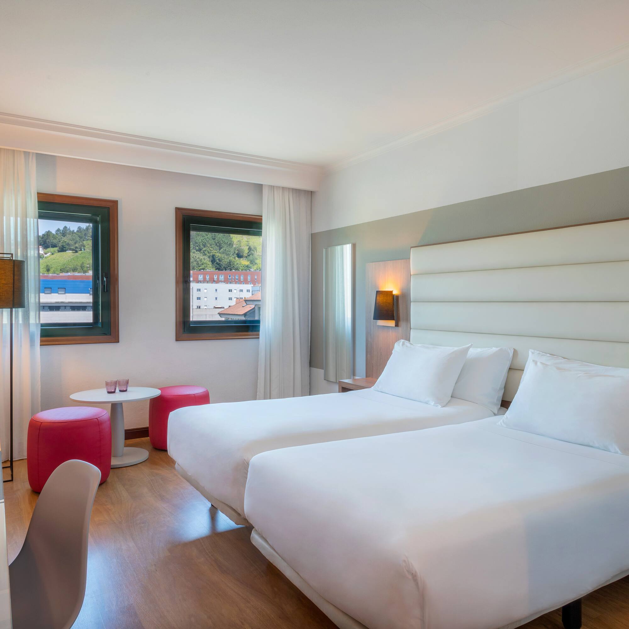 a room with two beds and a table