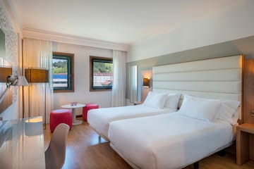 a room with two beds and a table