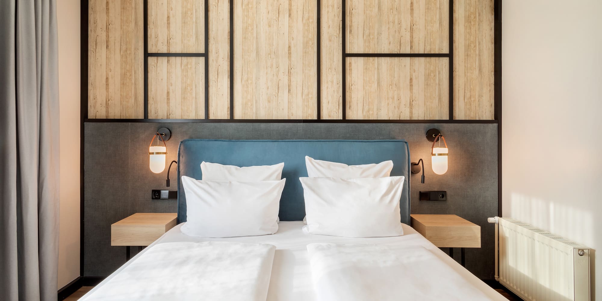 a bed with white pillows and a blue headboard