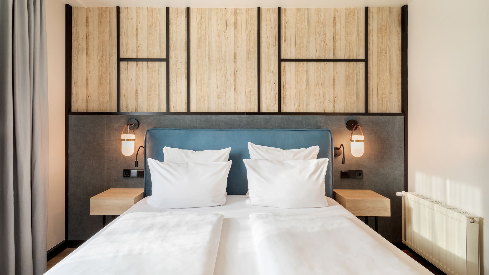 a bed with white pillows and a blue headboard