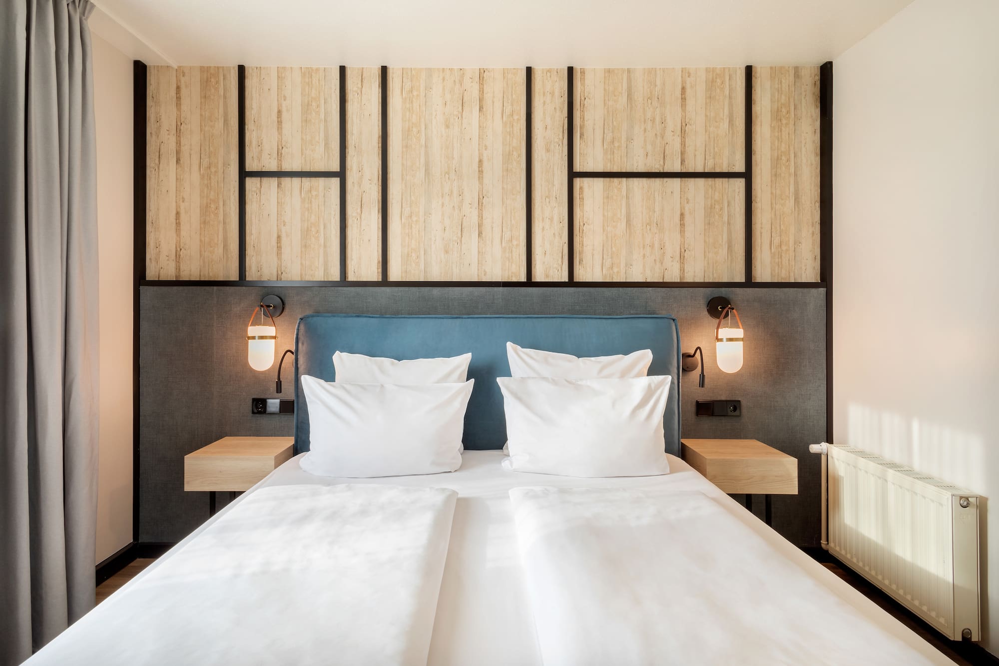 a bed with white pillows and a blue headboard