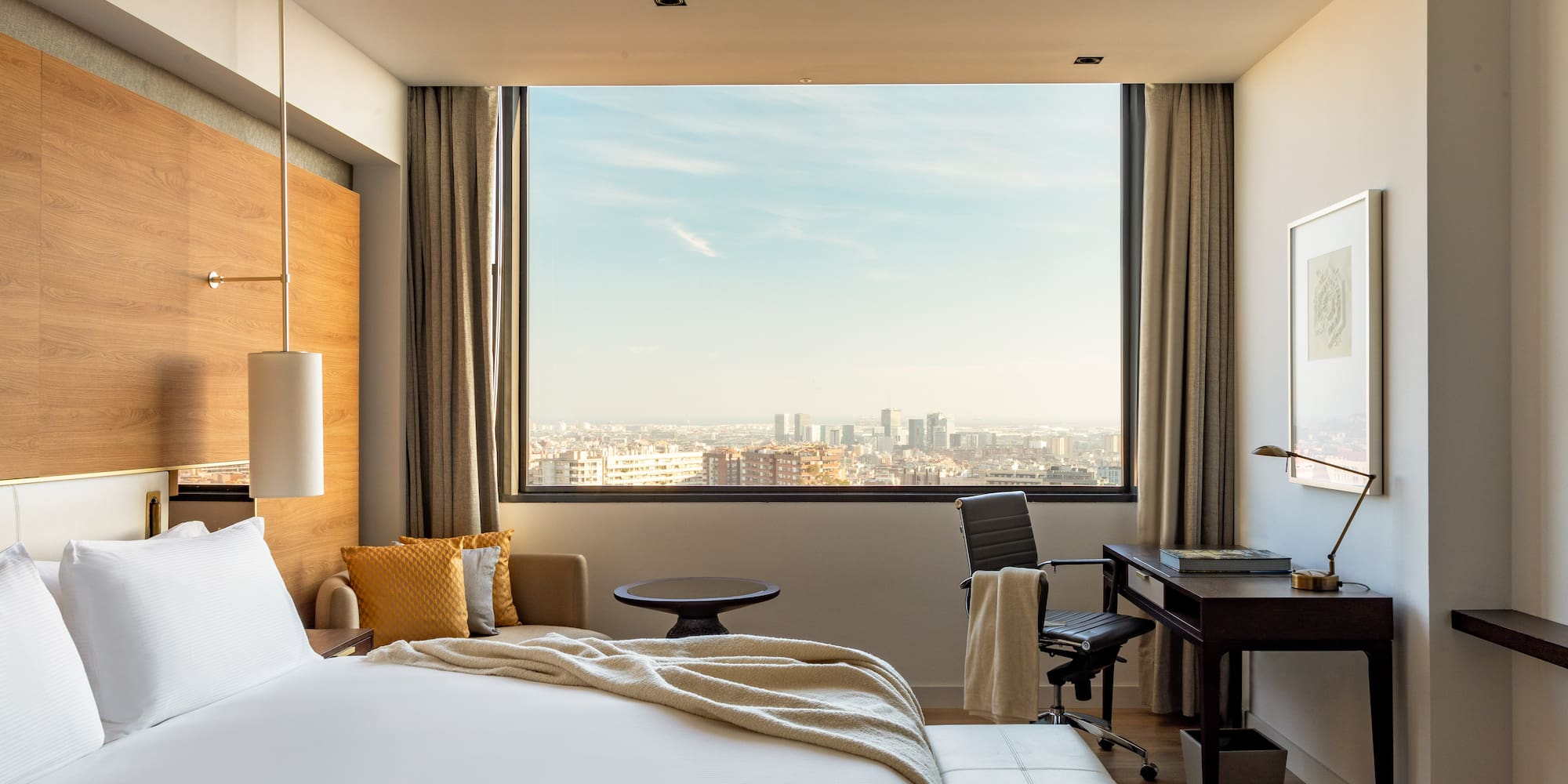 a room with a large window and a large bed