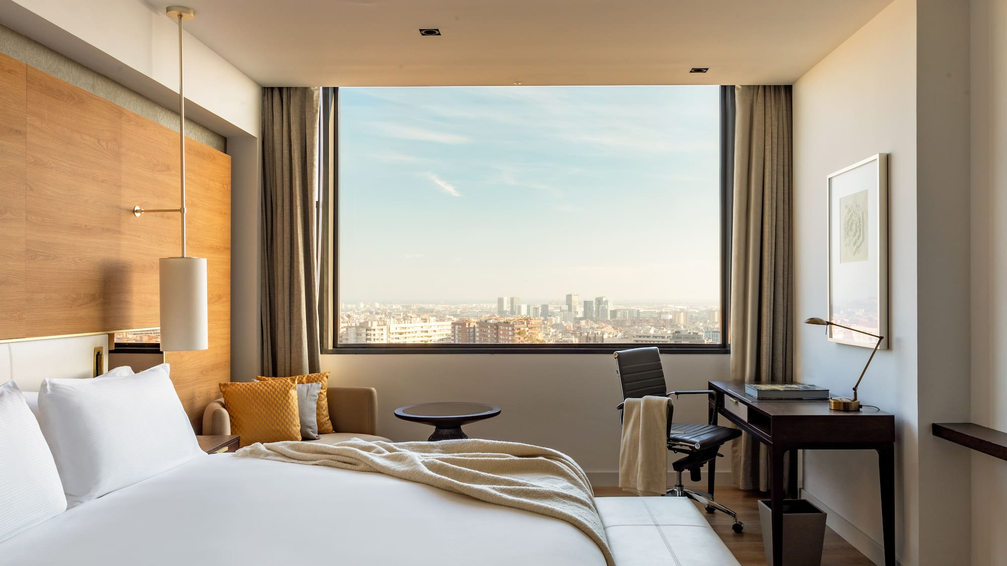 a room with a large window and a large bed