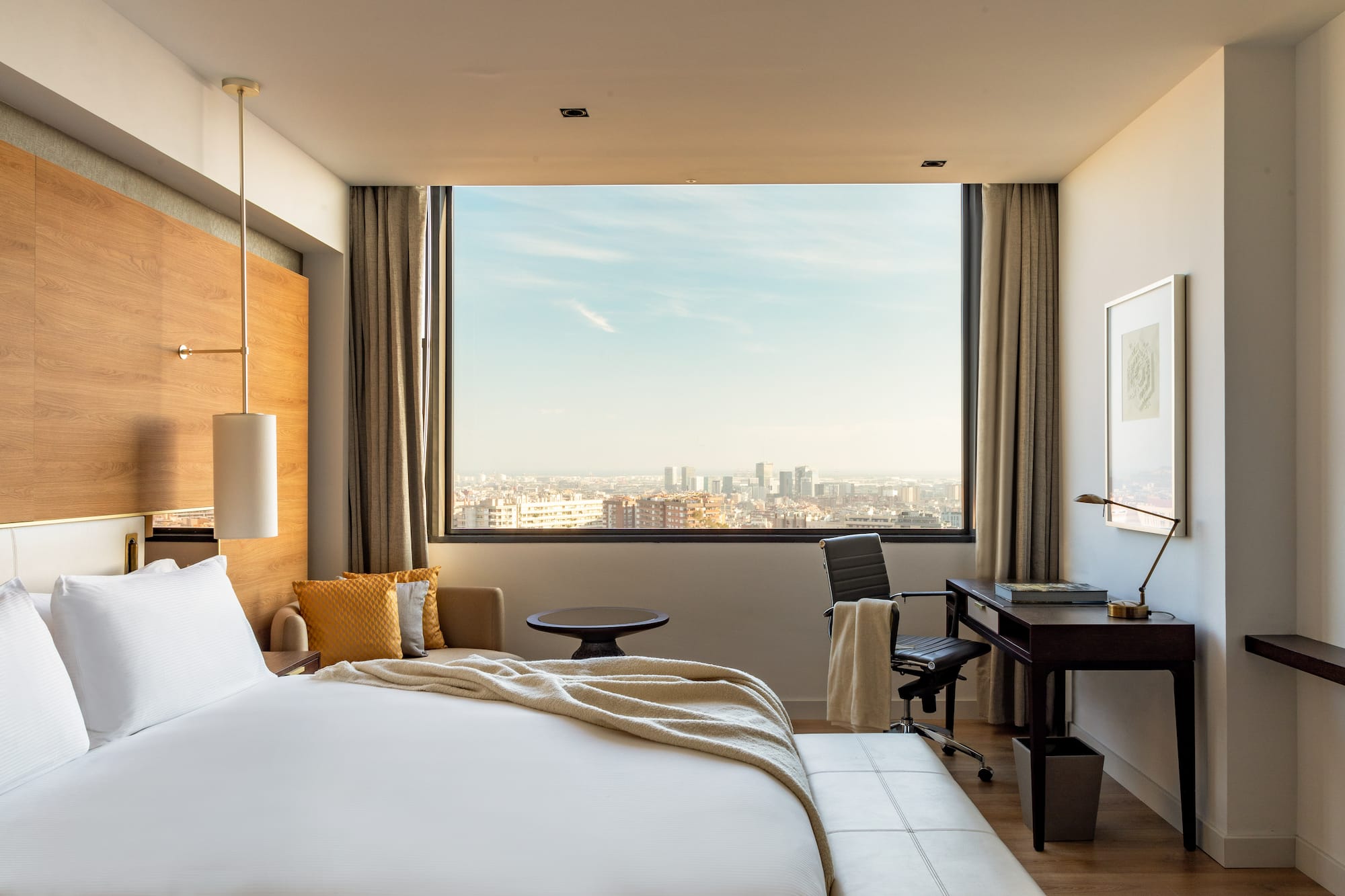 a room with a large window and a large bed