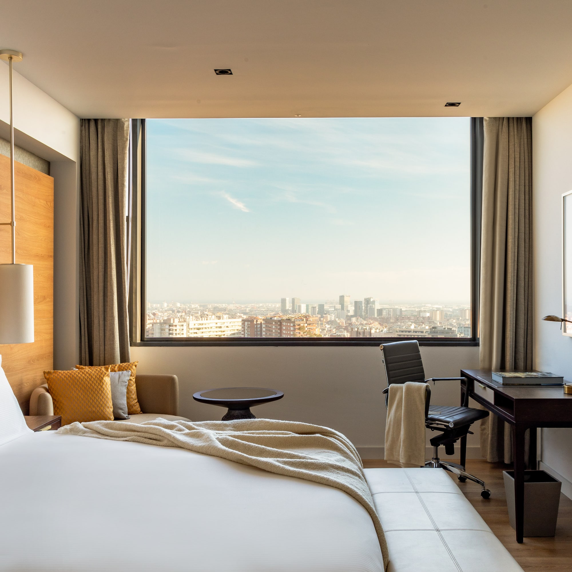 a room with a large window and a large bed