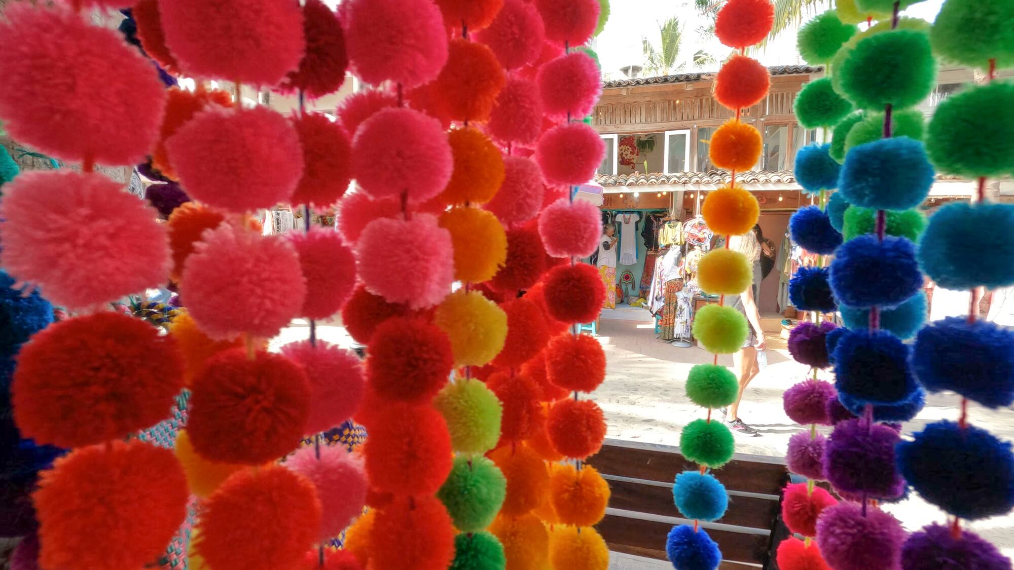 a colorful pom poms from a store window