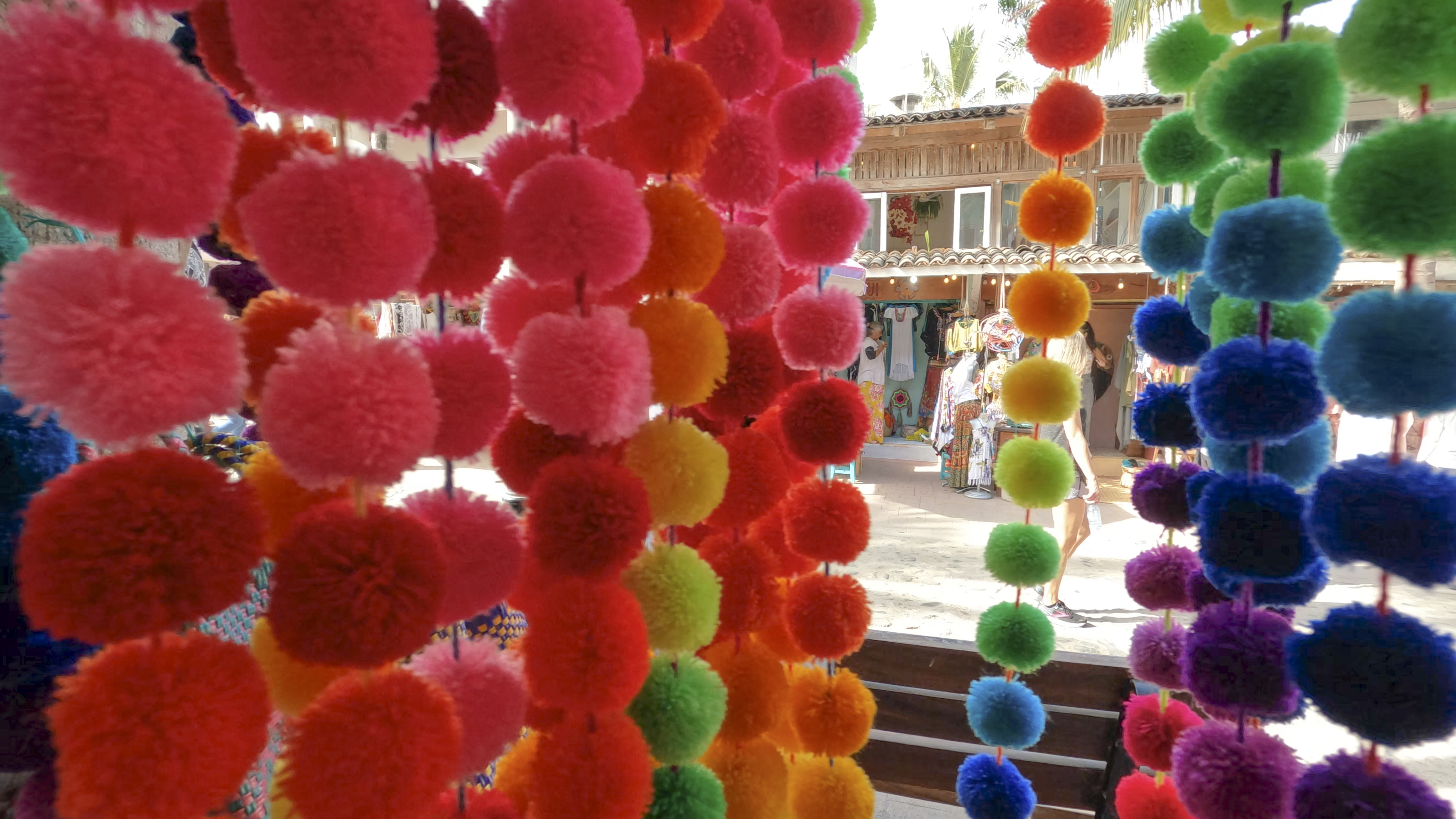 a colorful pom poms from a store window