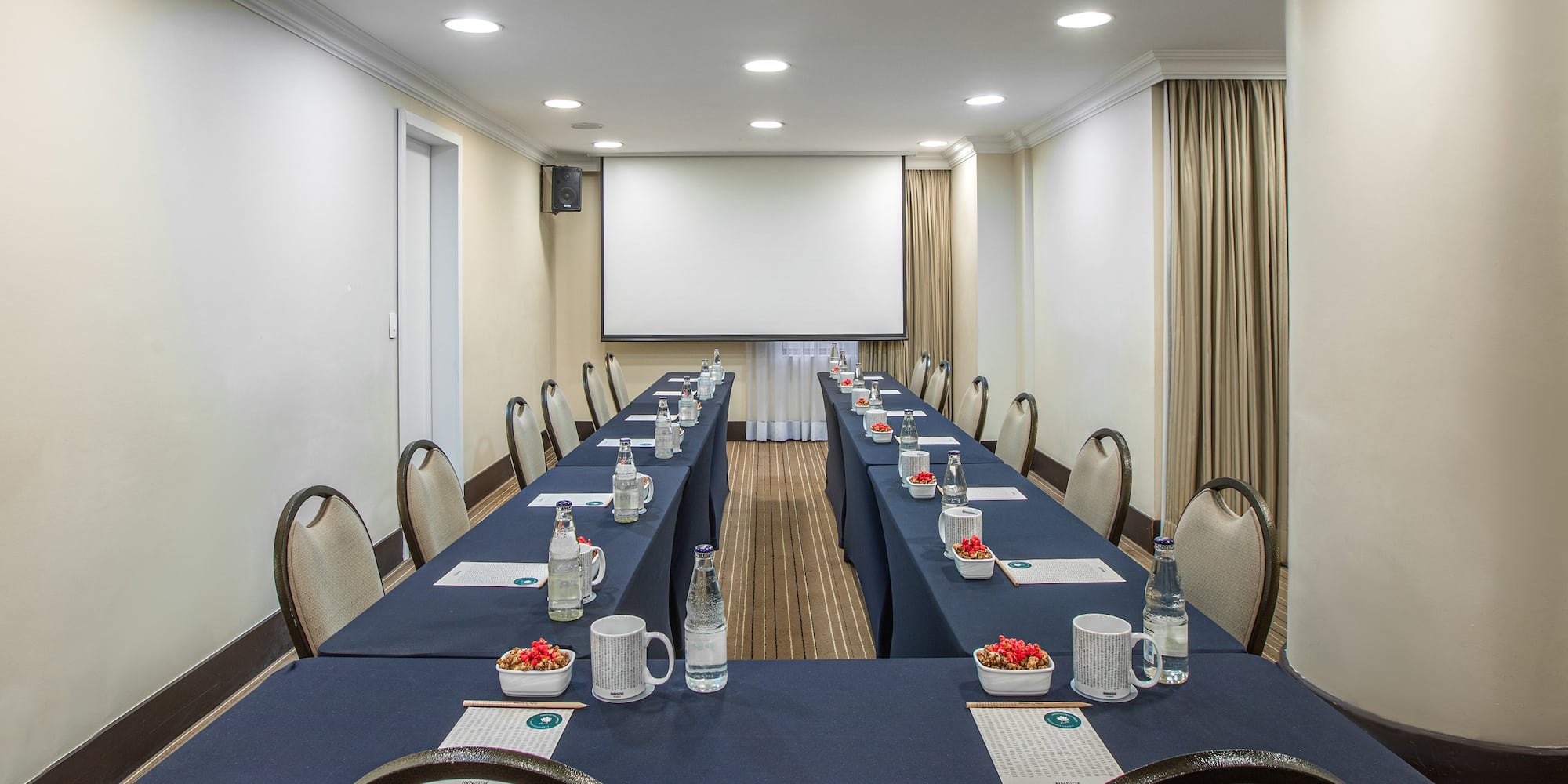a room with a large table and chairs