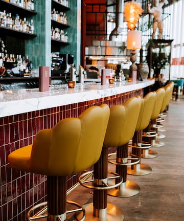 a row of chairs in a bar