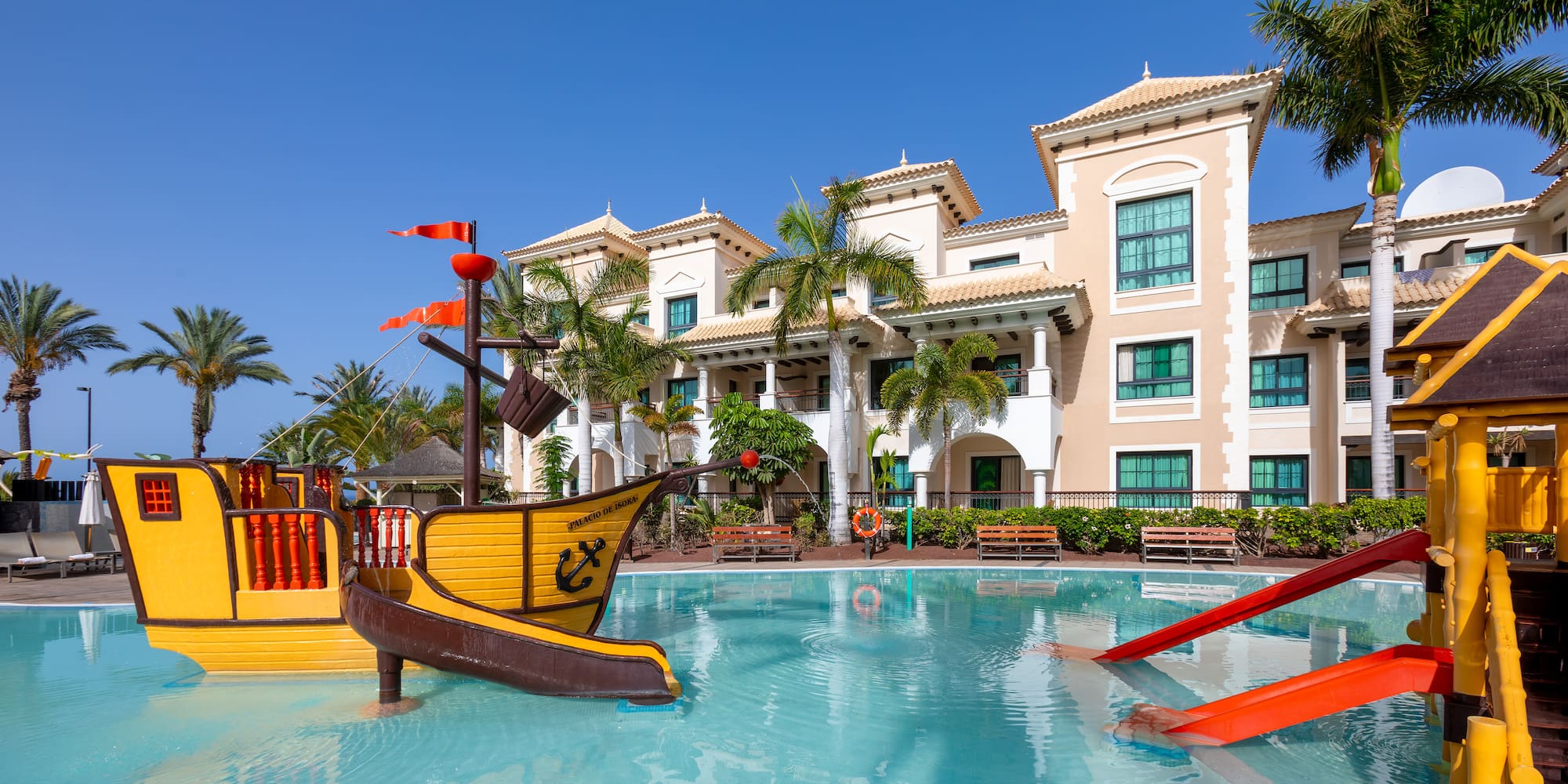 a swimming pool with a boat and slide in it