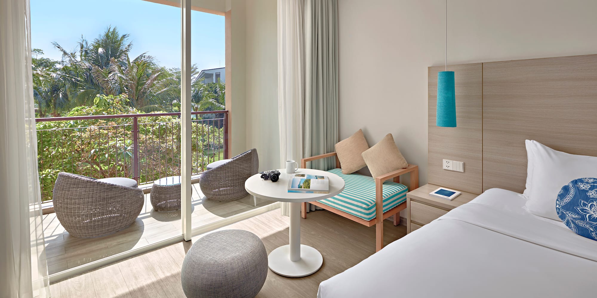 a room with a bed and a table and chairs