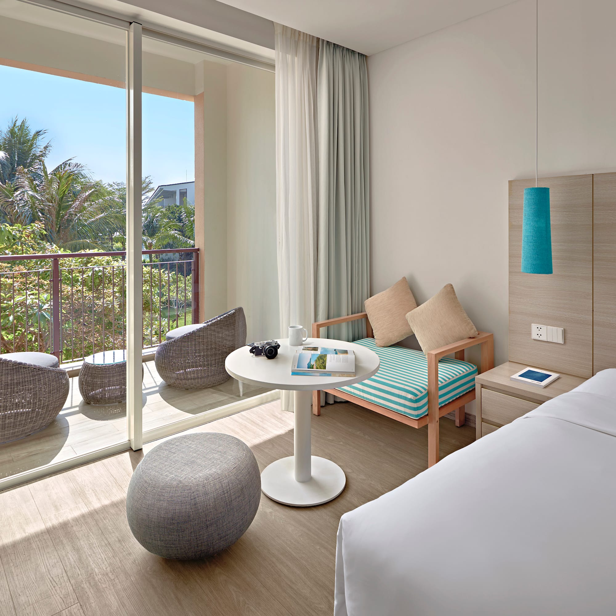 a room with a bed and a table and chairs