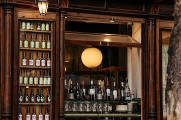 a store front with a sign and bottles of alcohol